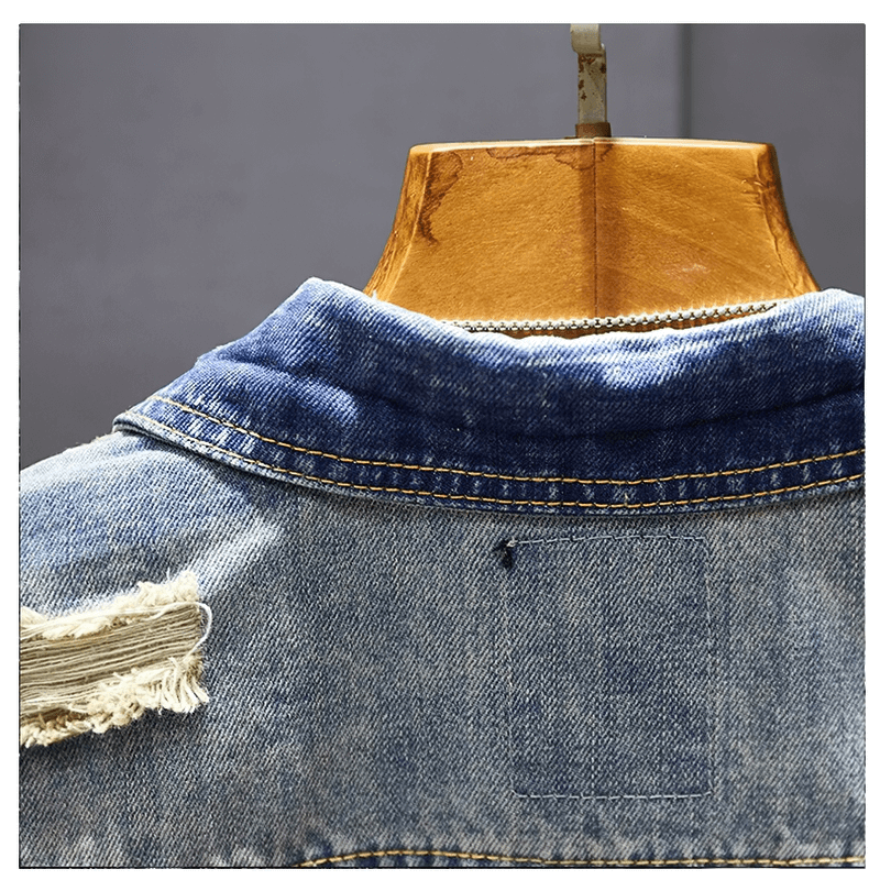 Stylish men's ripped denim jacket showing vintage design and unique abrasions, perfect for modern vintage wardrobes.