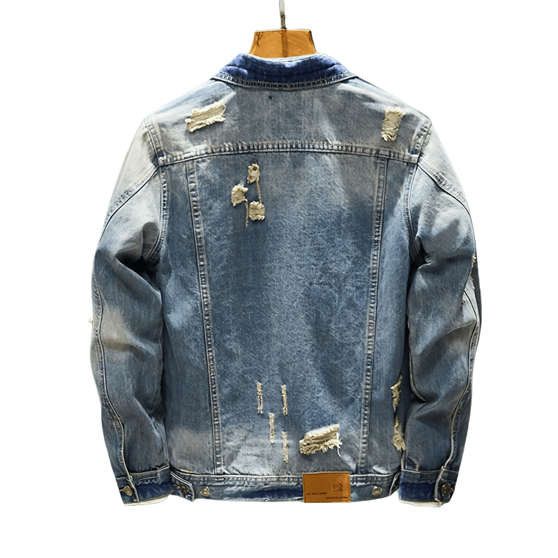 Stylish men's ripped denim jacket showcasing vintage design and detailed abrasions for a trendy look.