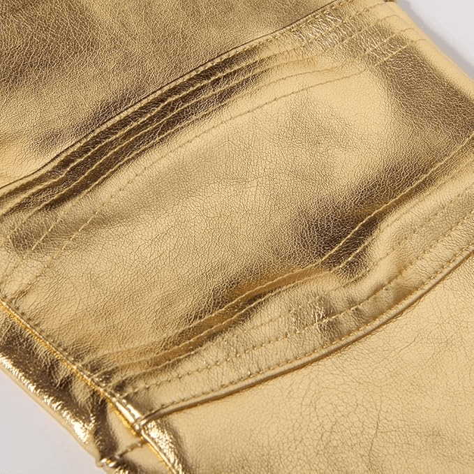 Close-up of shiny gold fabric of men's rock style skinny pants with detailed stitching and pockets.