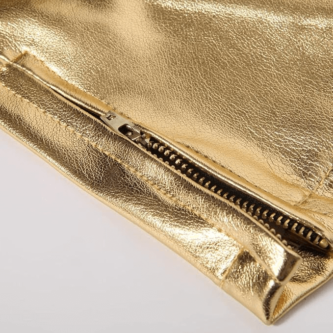 Close-up of stylish gold zipper on shiny rock style skinny pants for men, showcasing high fashion detail.