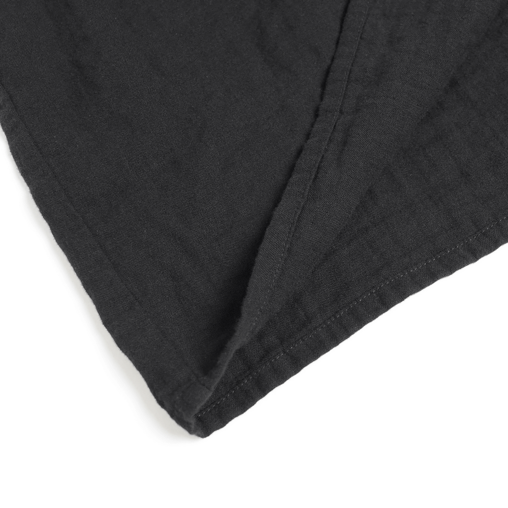 Men's Ruffled Shirt with Silver Clasps and Tattered Sleeves close-up of black fabric texture and stitching details.