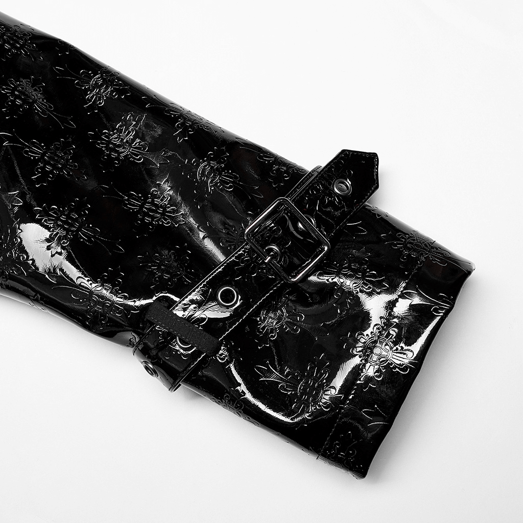 Close-up of the embossed patent leather sleeve of a men's gothic trench coat with a shiny buckle detail.