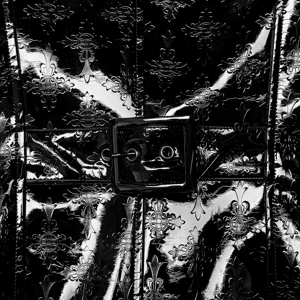 Close-up of men's gothic trench coat showcasing shiny embossed patent leather pattern and bold buckle detail.