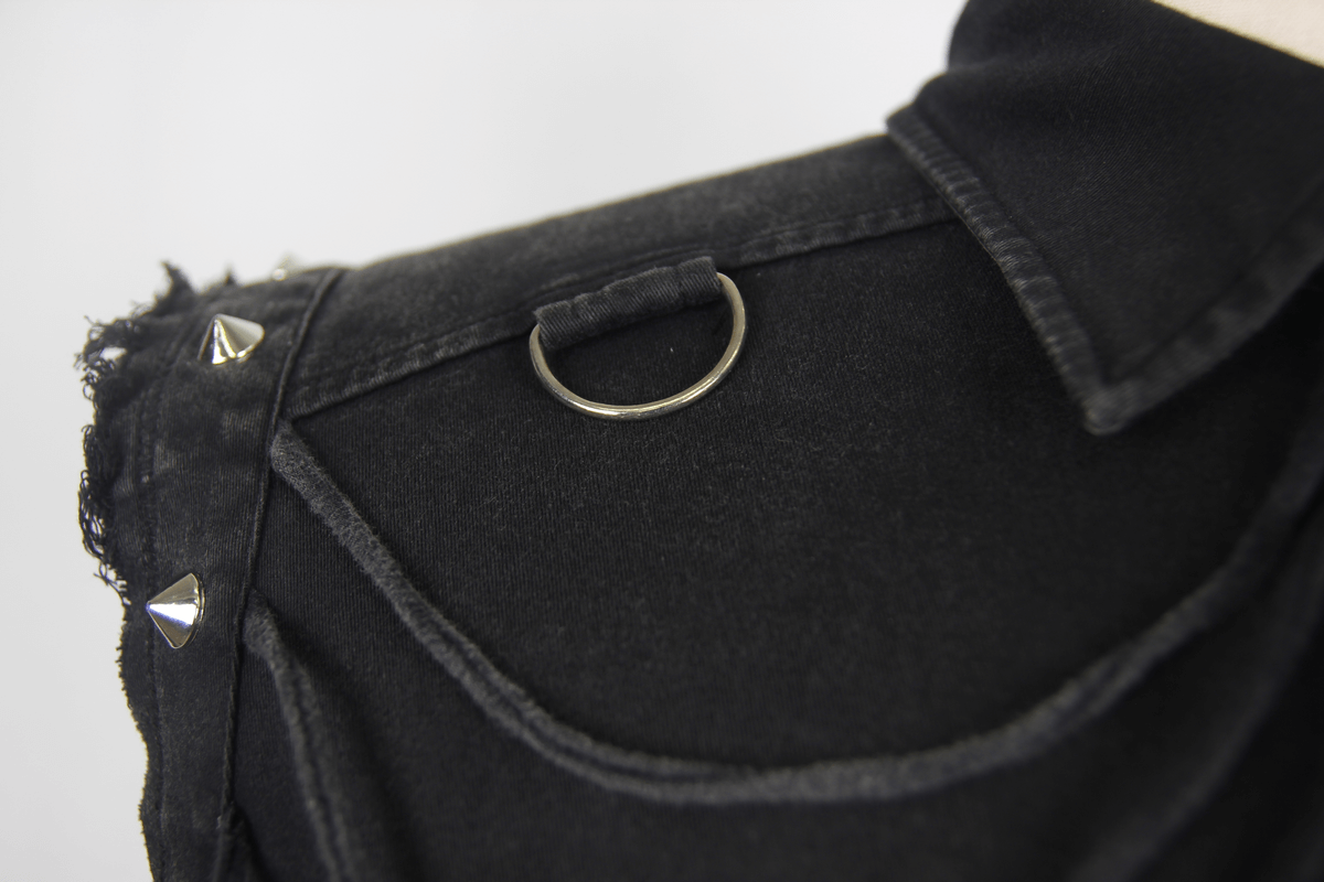 Close-up of men's sleeveless gothic shirt featuring silver rivets and decorative D-ring detail.