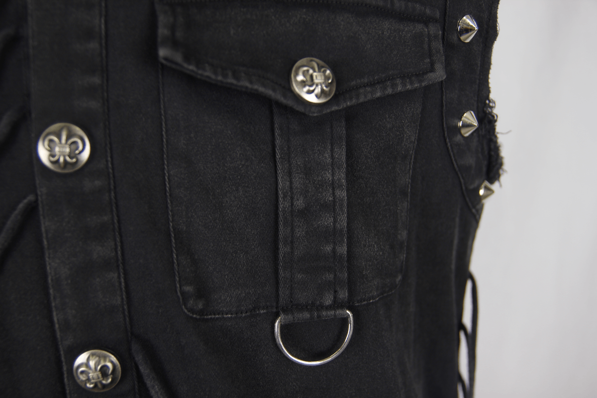 Close-up of a black men's sleeveless shirt featuring decorative silver buttons and gothic style rivets.