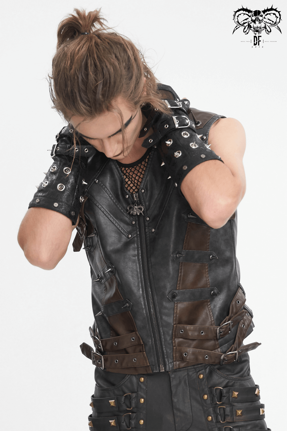 Stylish man adjusts his studded leather biker vest, showcasing edgy urban fashion and bold details.
