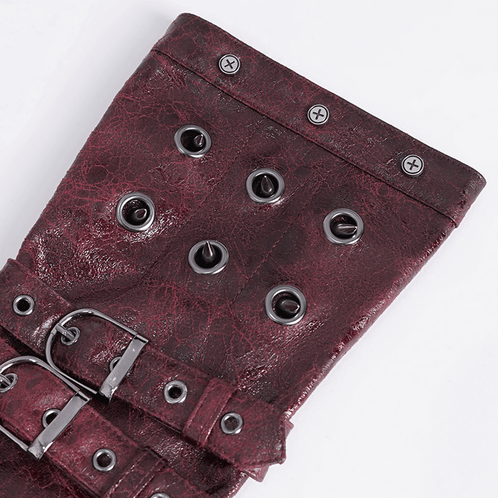 Close-up of maroon steampunk leather gauntlet featuring buckles and metal studs for a bold look.