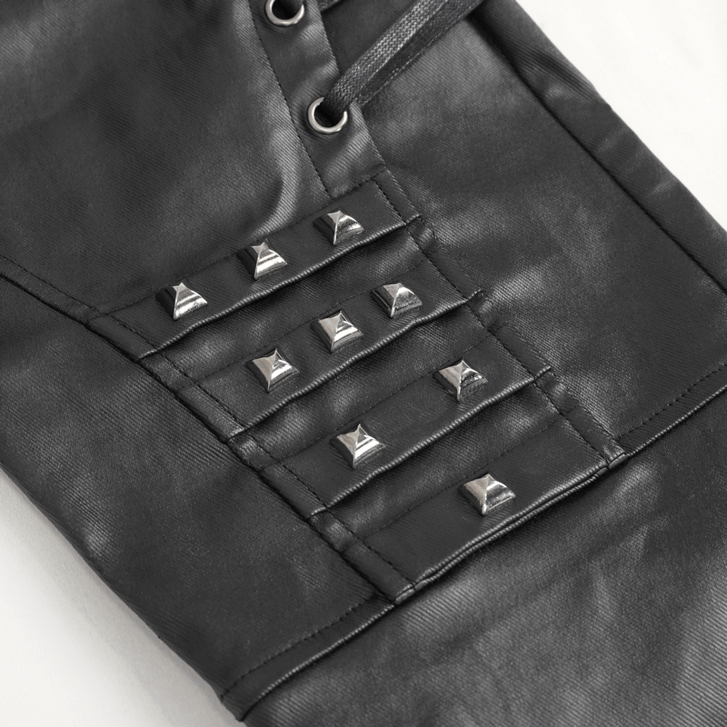 Close-up of men's black leather biker pants with metal accents, showcasing edgy design and style.