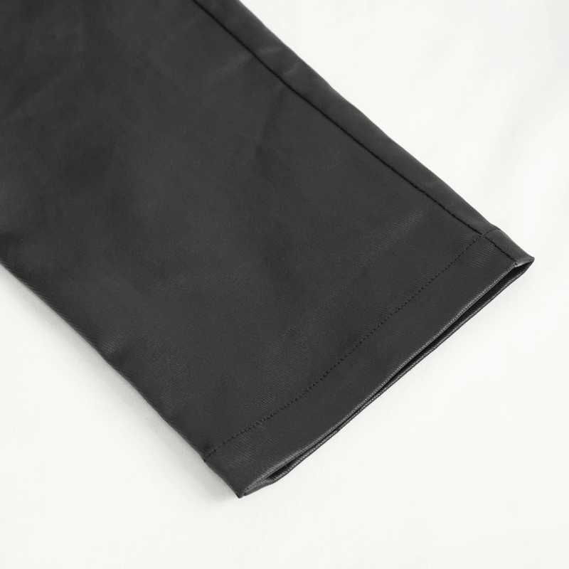 Close-up of the hem of men's stylish black leather biker pants with sleek design and premium finish.