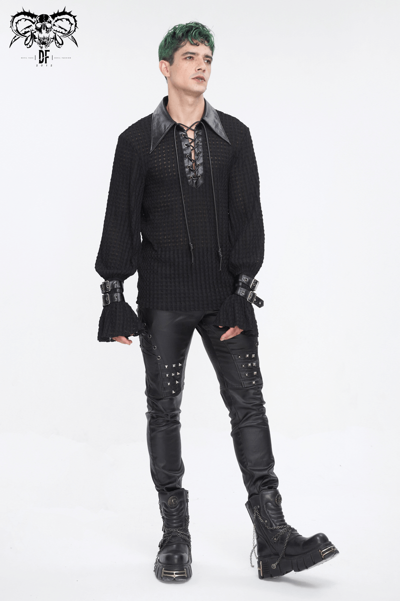 Model wearing stylish black leather biker pants with metal accents and a dark textured top, showcasing edgy fashion.