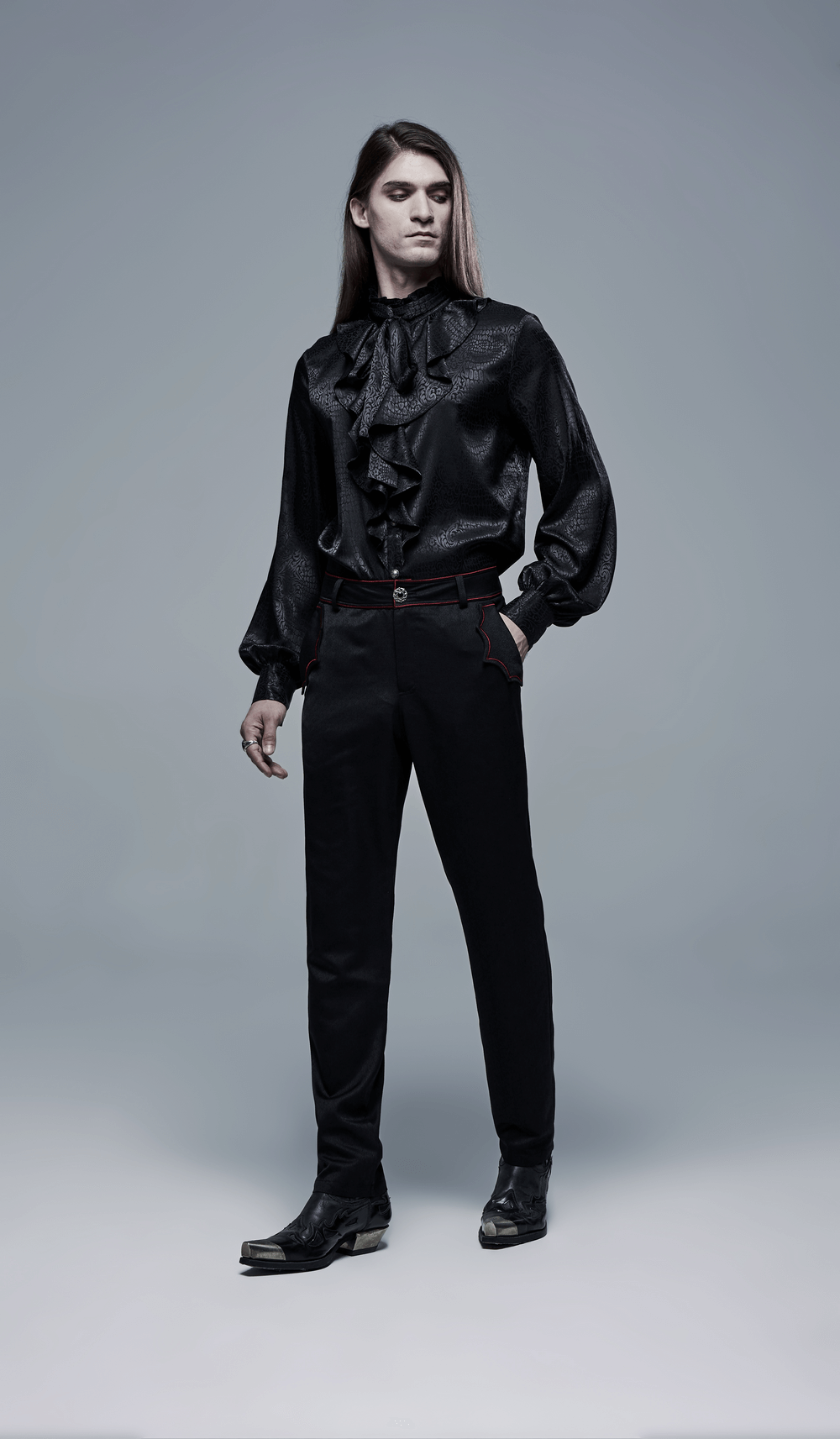 Men's dark aesthetic outfit featuring a ruffled black shirt and tailored dark trousers, embodying gothic elegance.