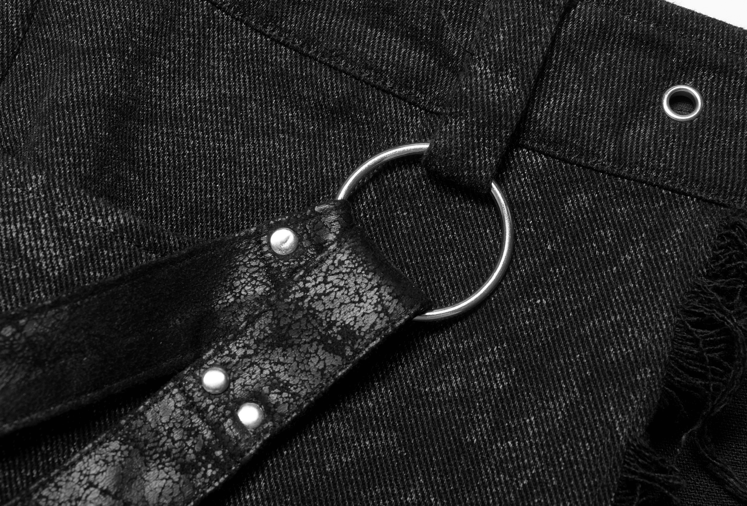 Close-up of the adjustable belt with detachable leather loop on a textured black men's gothic kilt.