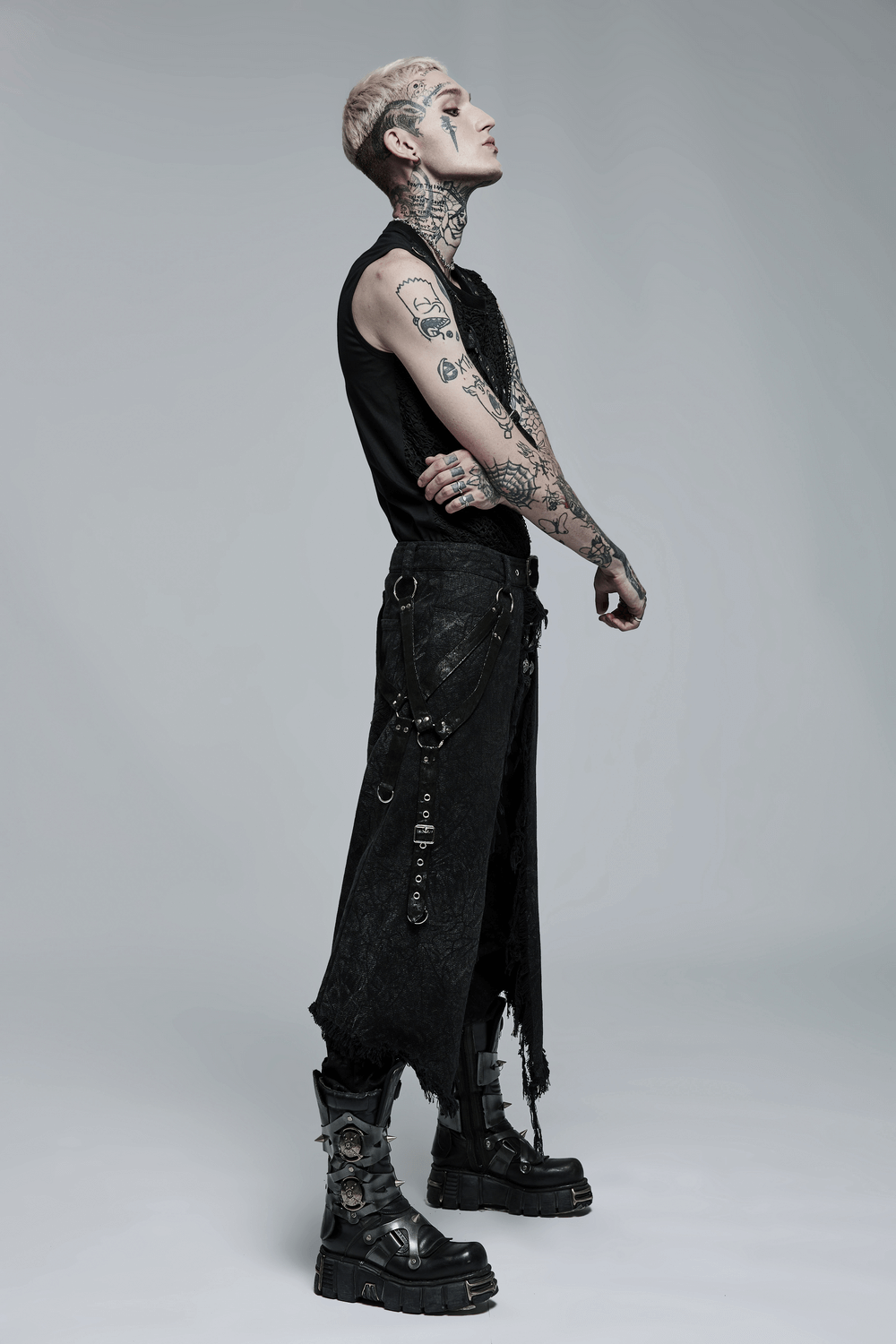 Stylish man wearing a men's textured gothic kilt with adjustable belt and combat boots, showcasing edgy fashion.