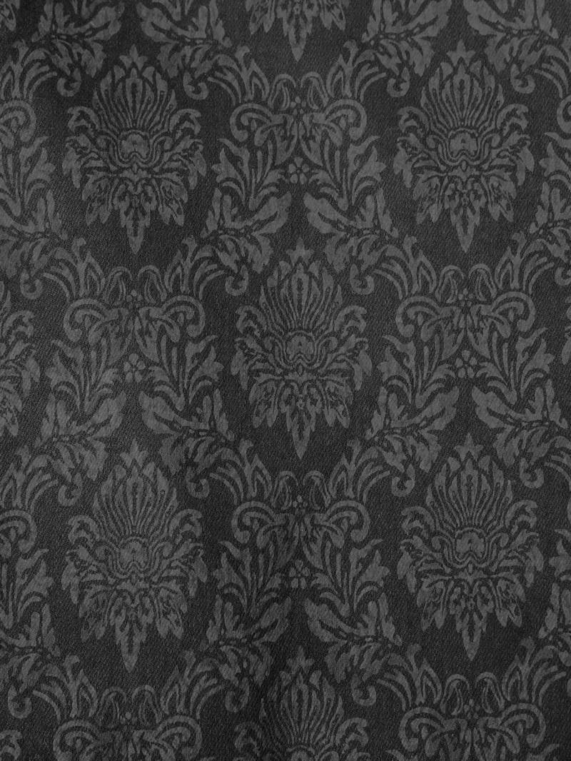 Intricate vintage black fabric pattern showcasing gothic-inspired designs for striking fashion aesthetics.
