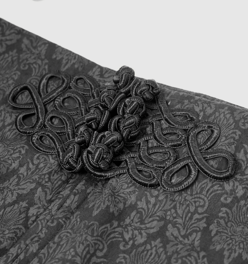 Close-up of decorative buttons on men's vintage gothic pants, showcasing intricate black patterns and elegant design.