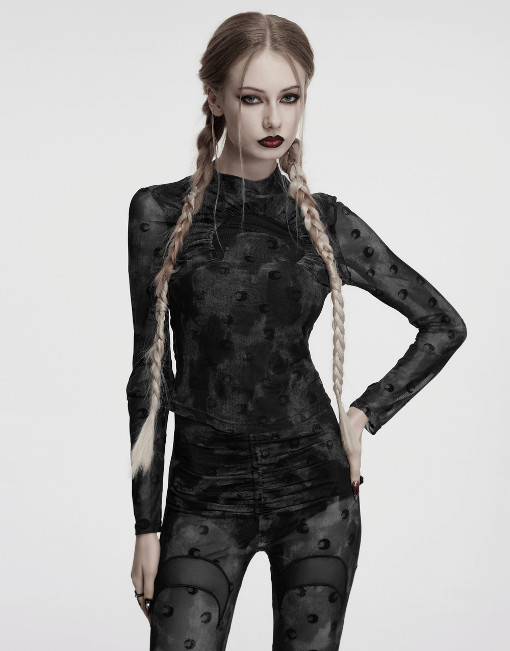 Model wearing a black mesh crescent print long sleeve top with high collar, showcasing gothic style and unique design.