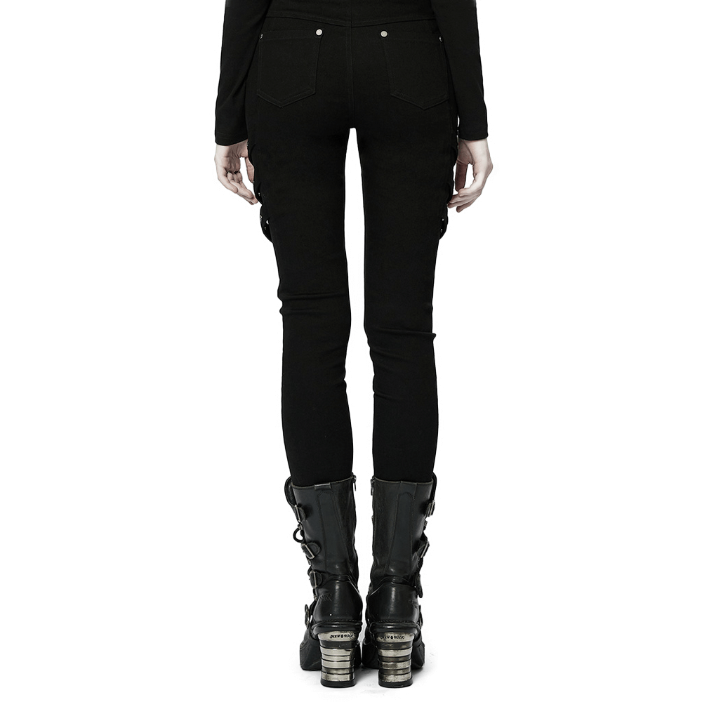 Back view of sleek black skinny punk pants with mesh detail and stylish zigzag buckles, paired with edgy boots.