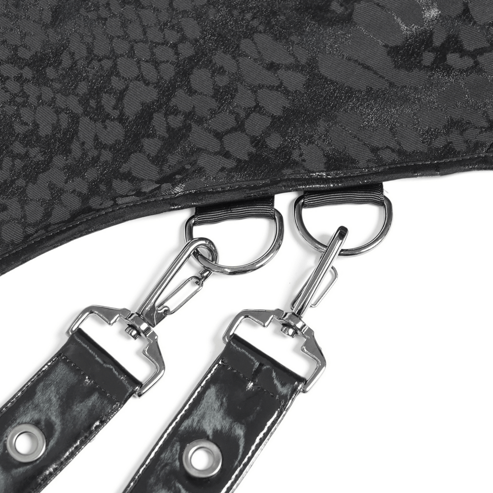 Close-up of snake-textured fabric with faux leather straps and metal buckles for a gothic dress.