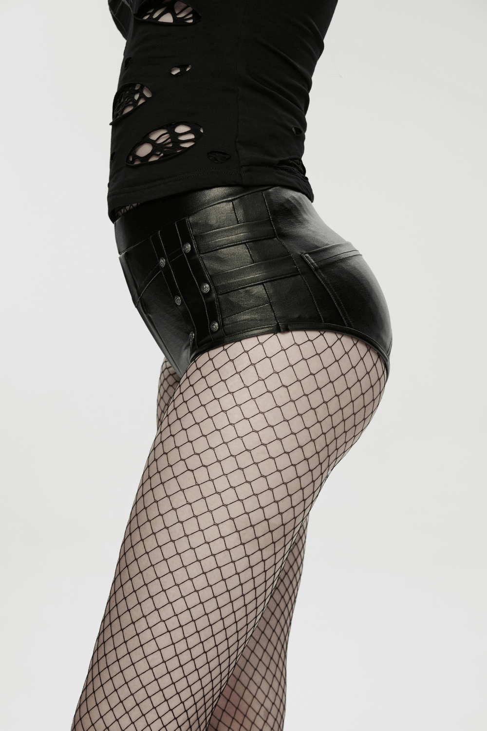 Model showcasing Metal Punk Hot Pants with Side Buttons and Stretch Fit paired with fishnet tights for a bold look.