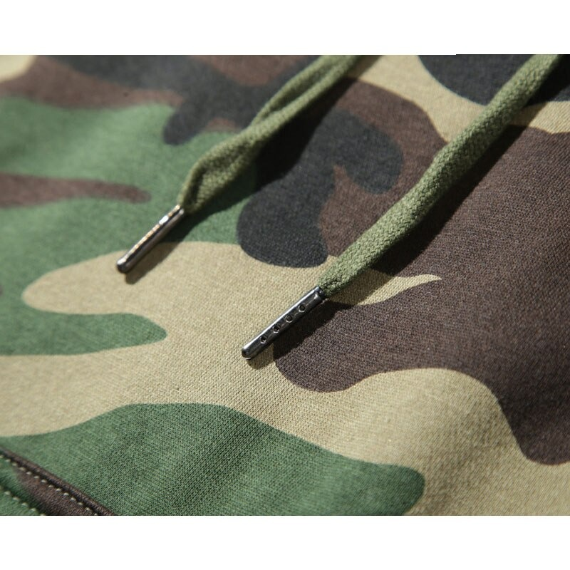 Close-up of army green camouflage hoodie fabric with detailed drawstrings. Comfy casual style for men.