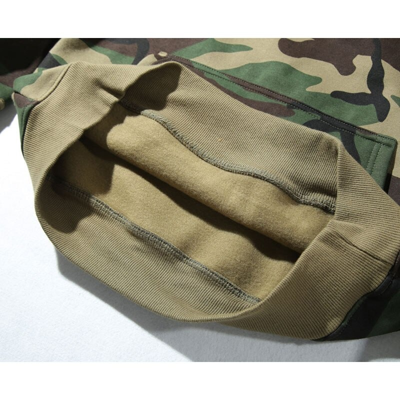 Close-up of the cozy interior lining of a military green hoodie with camouflage print for men.