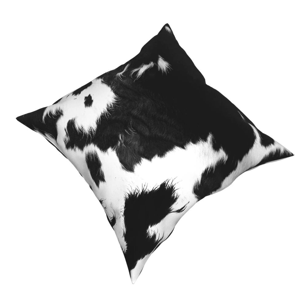 Black and white cowhide polyester pillow, perfect for modern home decor and creative styling.