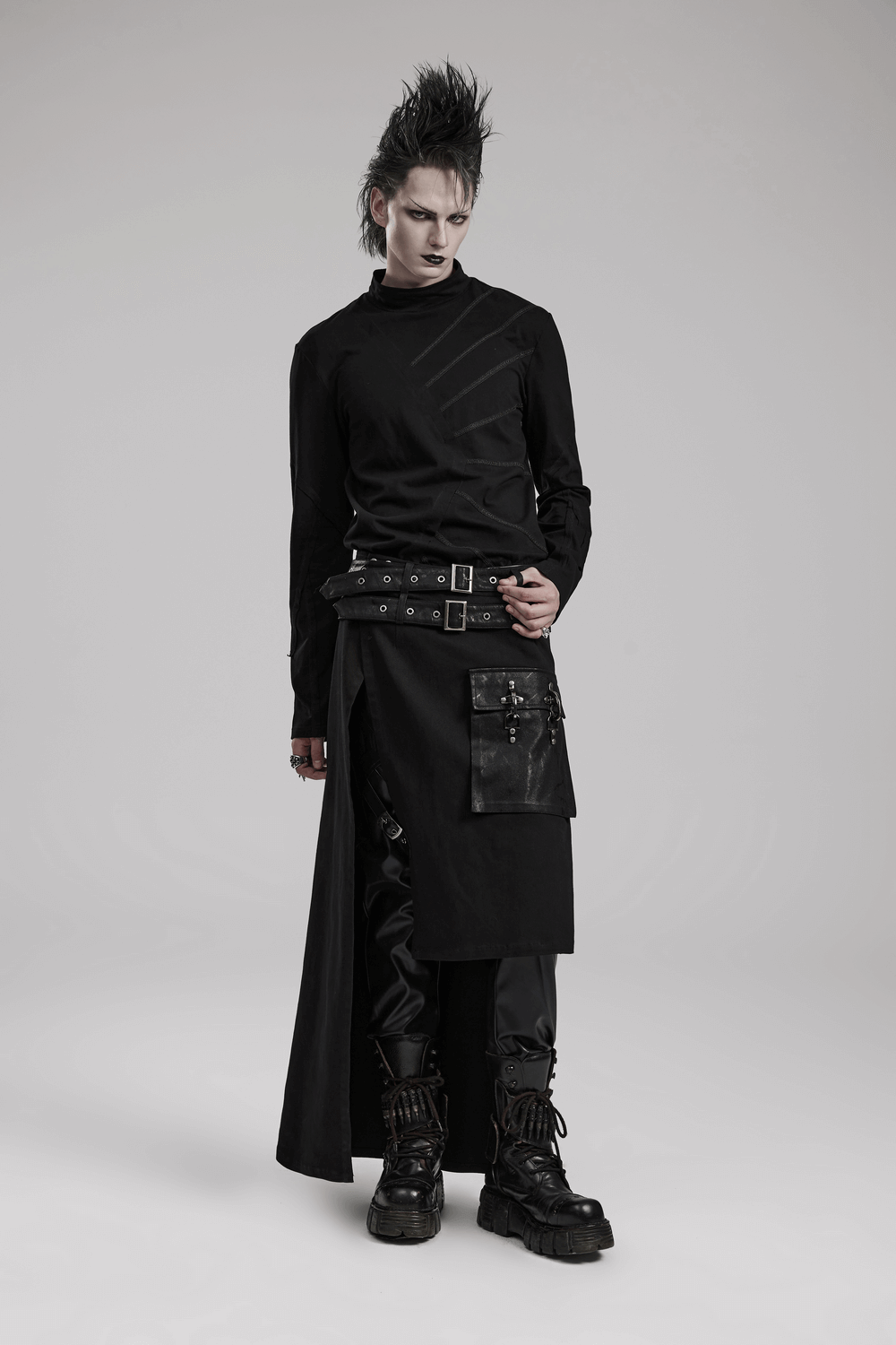 Edgy model in modern punk utility kilt with pocket and detachable loops, showcasing avant-garde fashion style.
