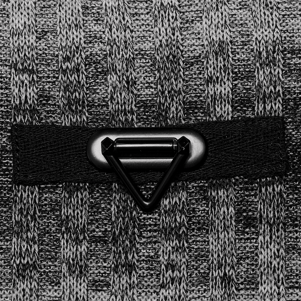 Close-up of a metal buckle detail on a monochrome striped punk sweater, showcasing its stylish design and cozy fabric.