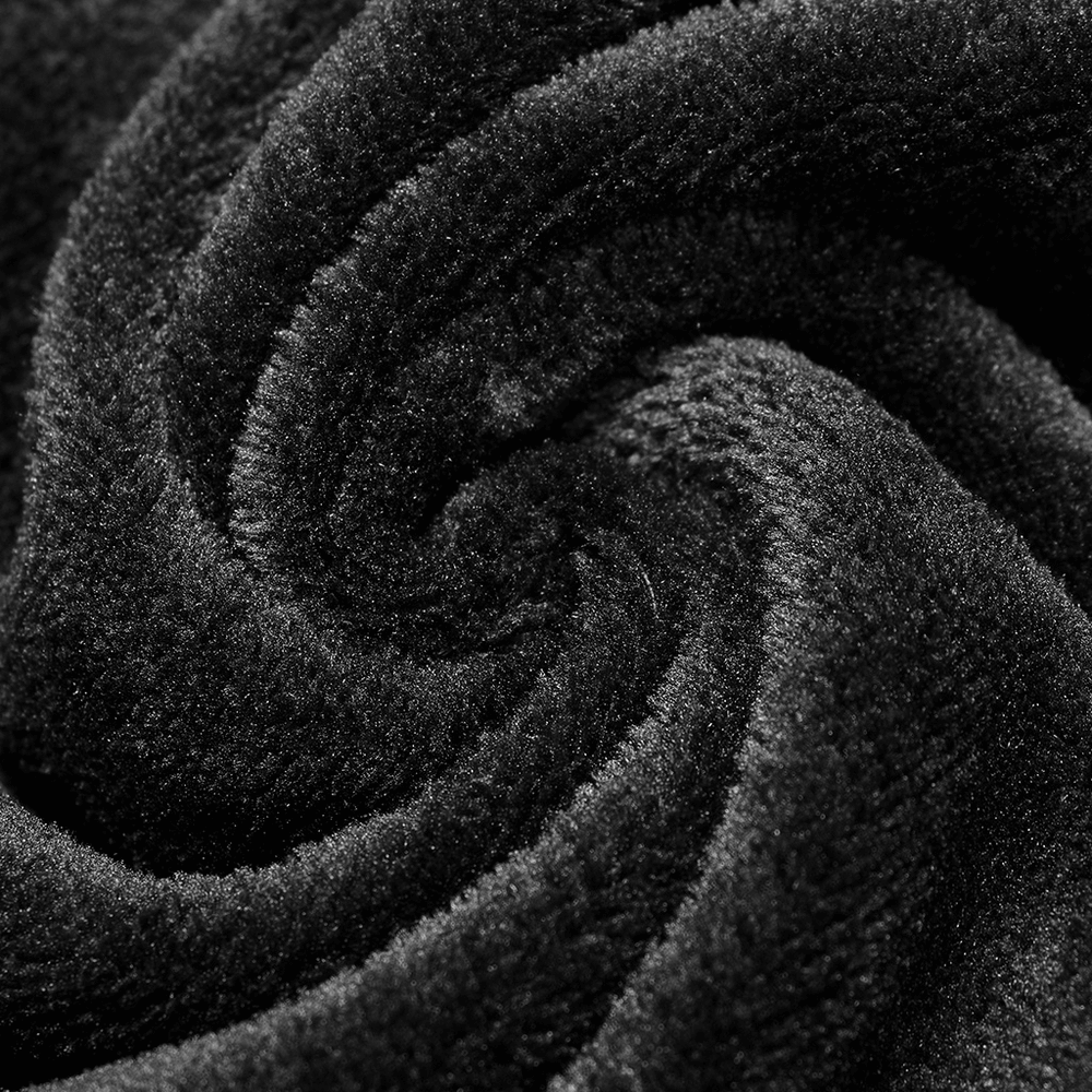 Close-up of soft black velvet fabric, showcasing its plush texture and deep color for stylish apparel.
