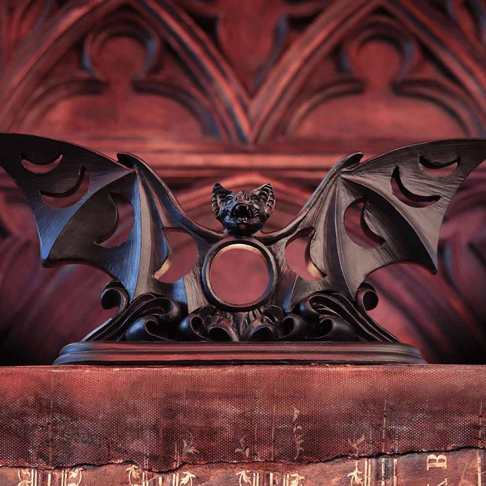 Gothic bat tea light holder with moon phases cutout design, perfect for eerie home decor.