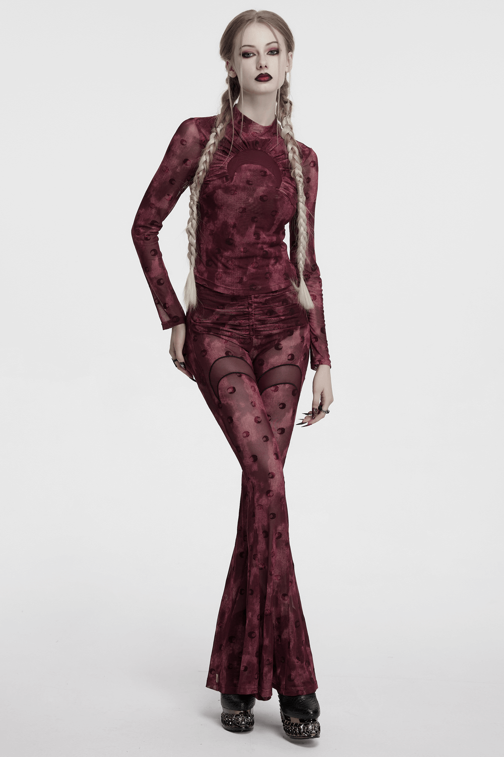 Model wearing moon printed mesh flare pants with crescent embroidery, showcasing a bold gothic fashion style.
