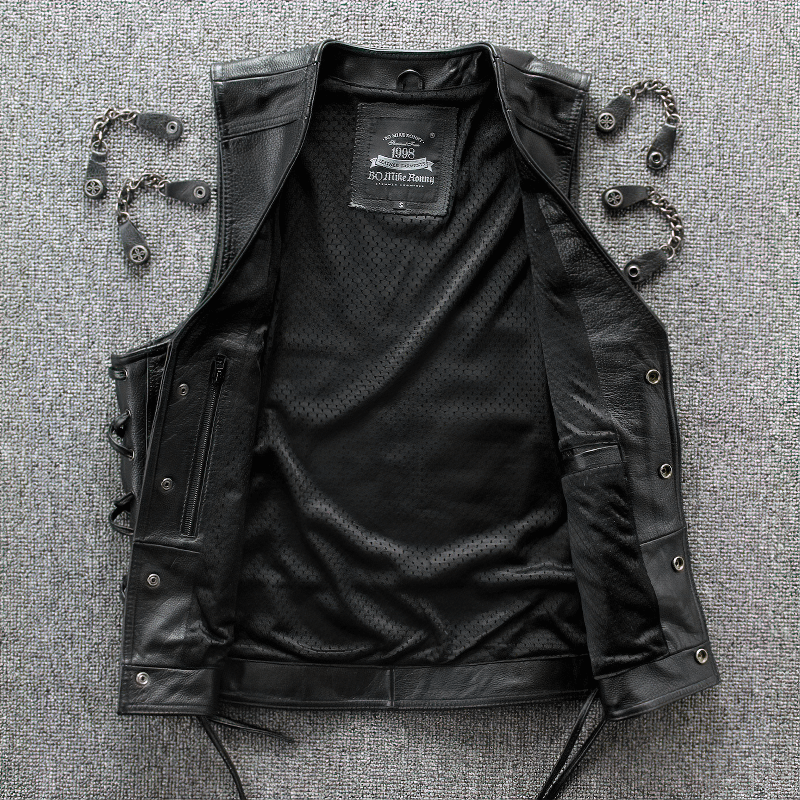 Interior view of a solid black men's leather vest with stylish chains and pockets, perfect for biker enthusiasts.