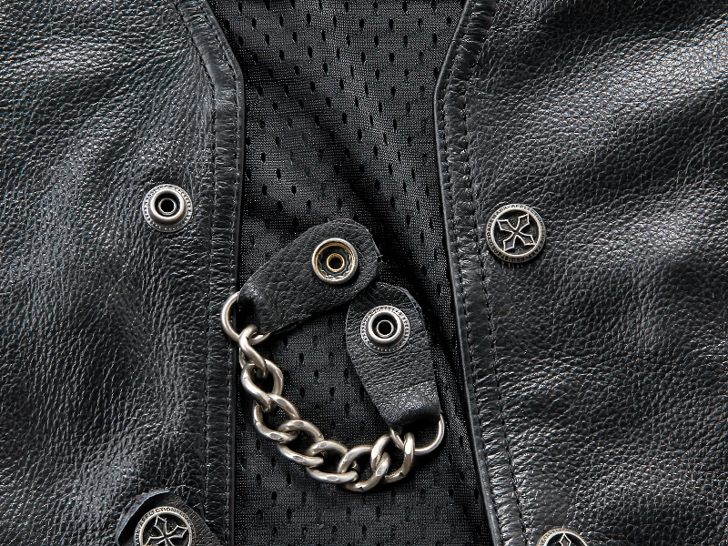 Close-up of a Moto Biker Leather Vest featuring stylish chain and button details on black fabric.