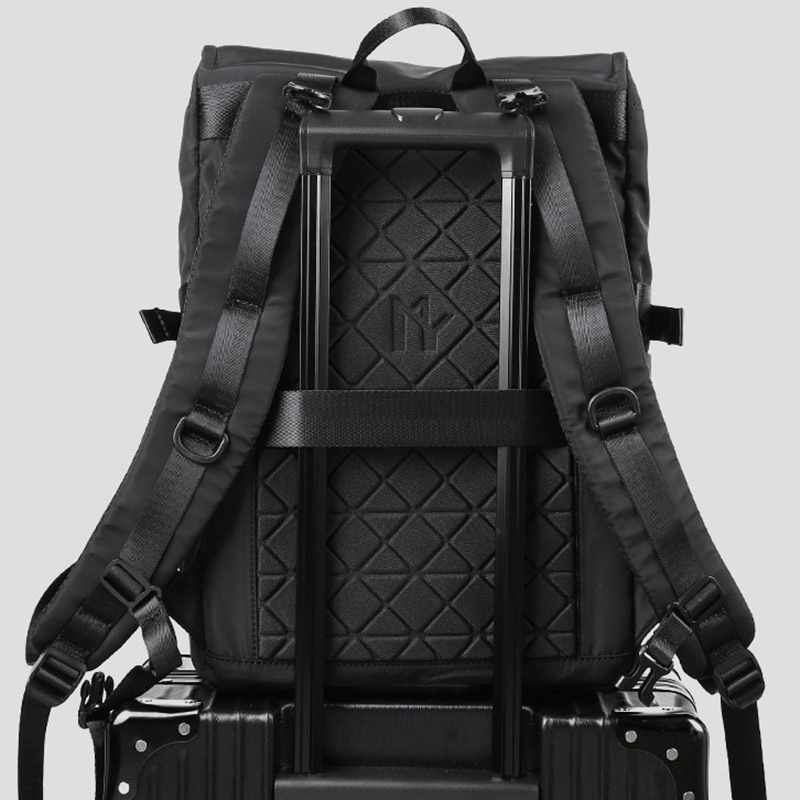 Stylish motorcycle waterproof backpack, showcasing wear-resistant design and backpack straps on a suitcase.