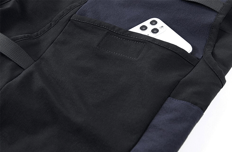 Close-up of tactical cargo shorts featuring a smartphone tucked in a pocket, showcasing practicality and style.