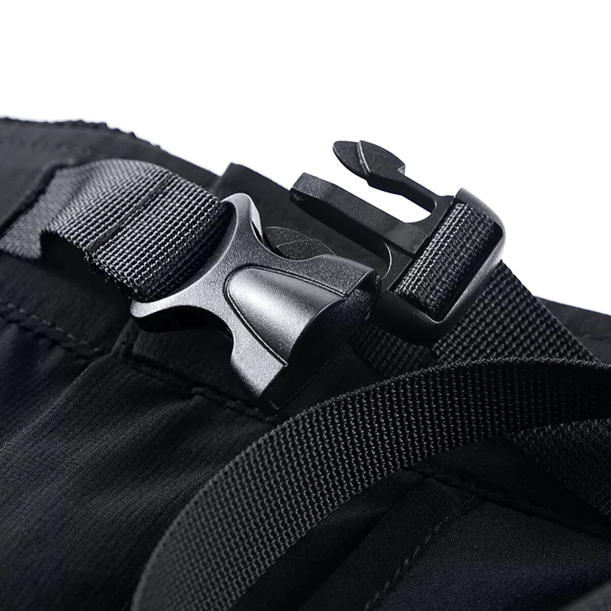 Close-up of black buckle and strap on cargo shorts, highlighting the tactical design and adjustable fit.
