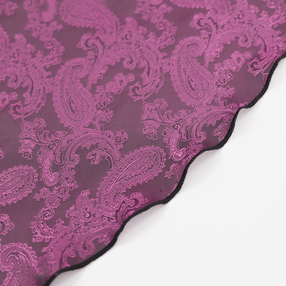 Close-up of intricate black and purple lace fabric featuring a paisley pattern, perfect for gothic fashion designs.