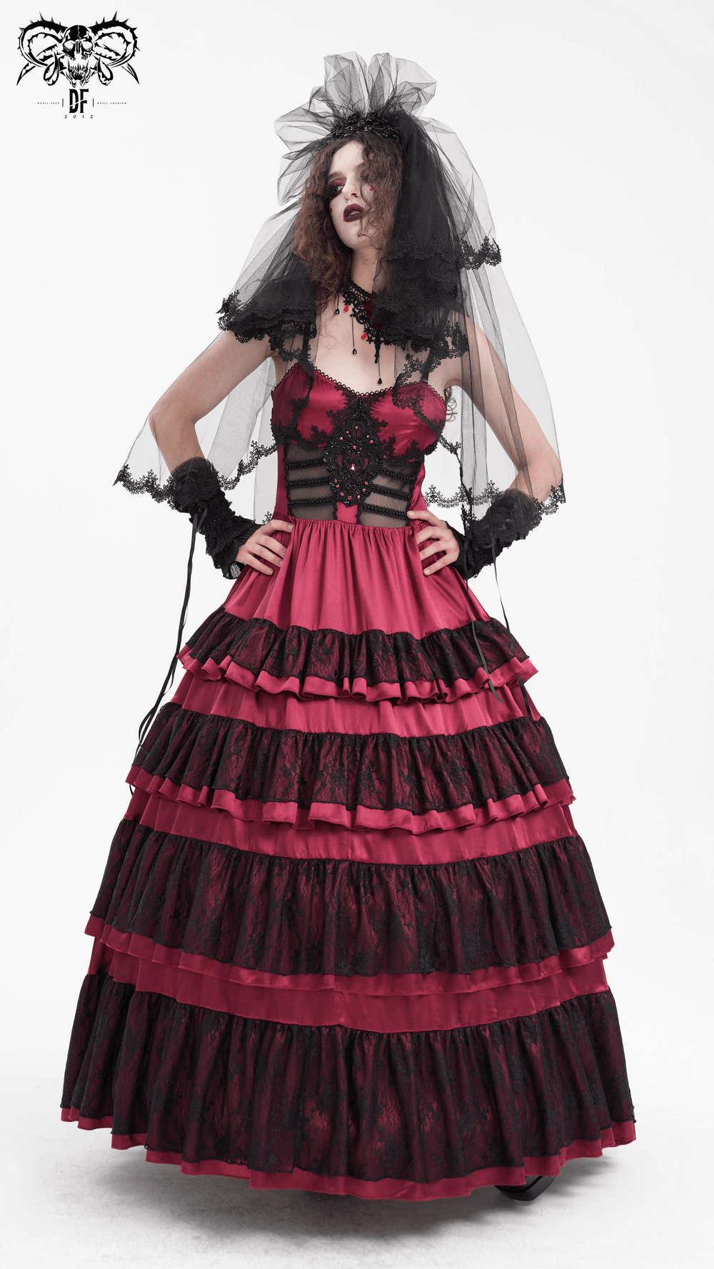 Elegant model in a black lace bridal veil and a striking red and black gown, perfect for alternative weddings.