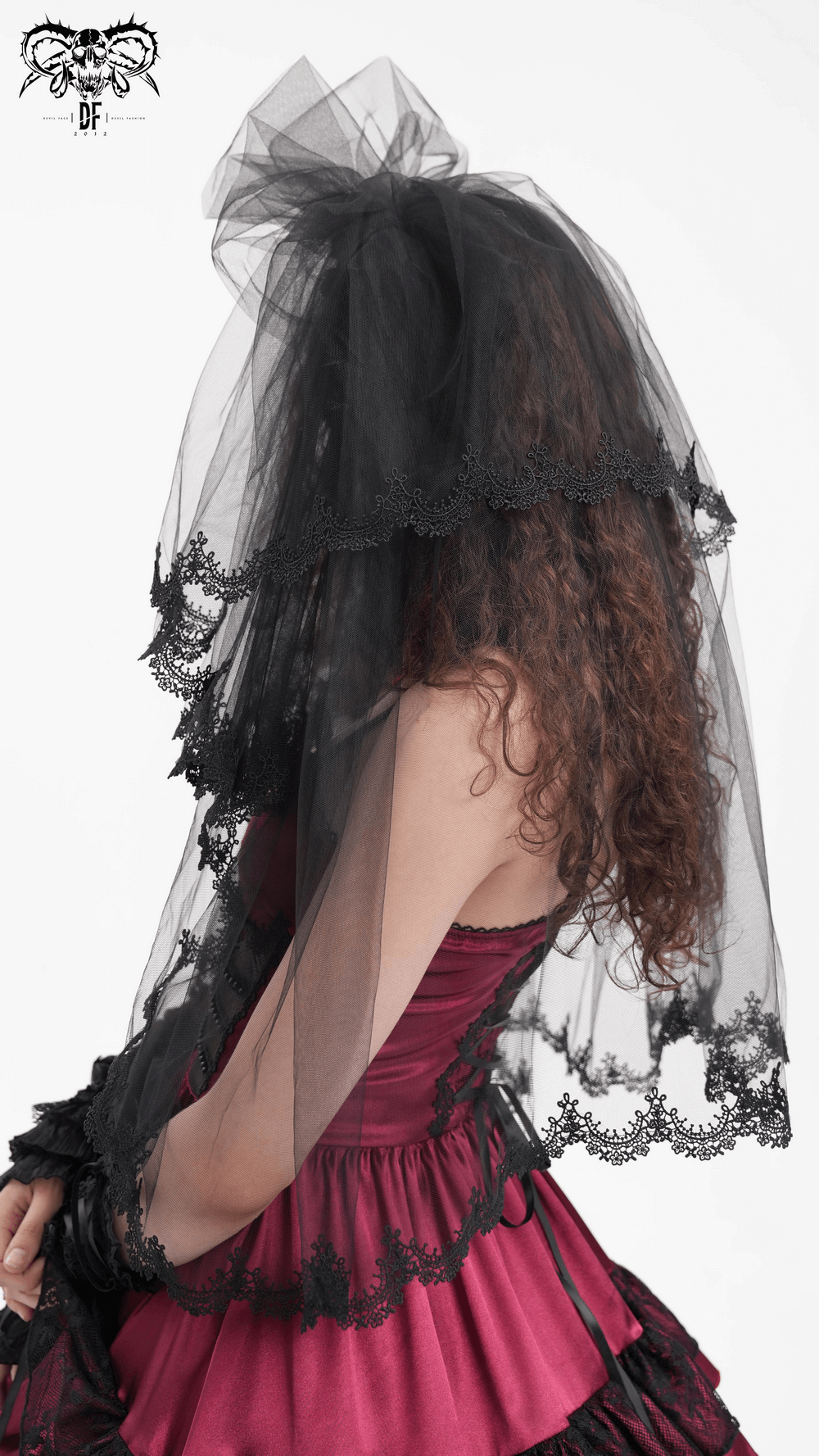 Elegant black lace bridal veil worn by a bride, adding sophistication and mystery to her wedding attire.