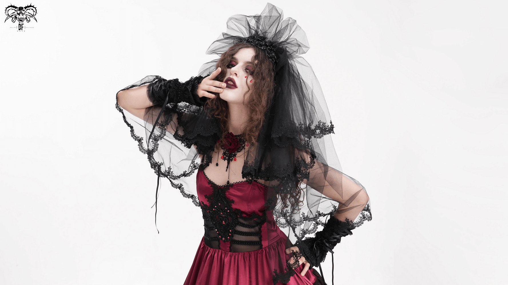 Mystery elegant black lace bridal veil paired with a sleek red dress, perfect for a gothic wedding look.