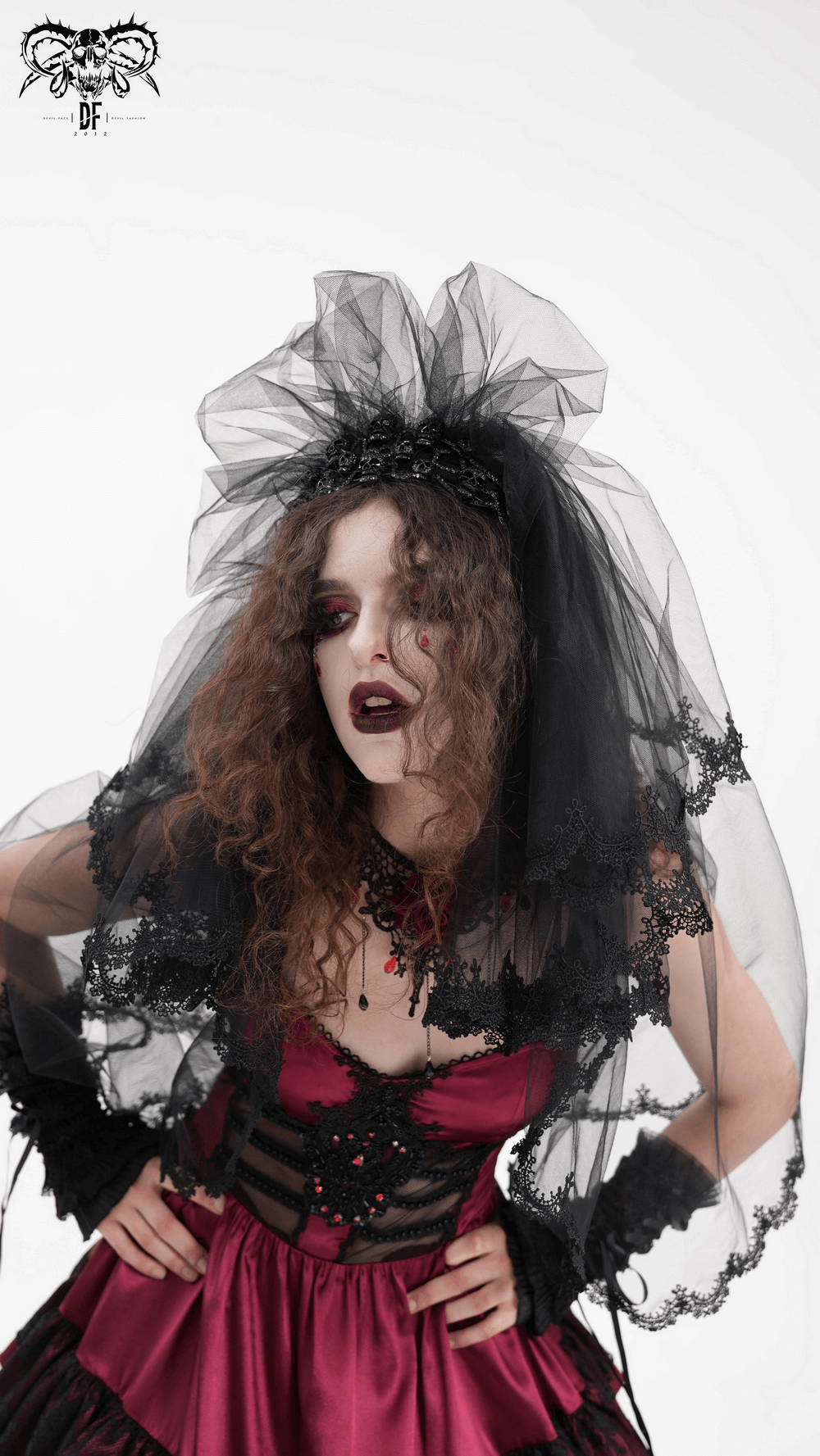 Model wearing an elegant black lace bridal veil with a dramatic tulle overlay and striking lipstick.