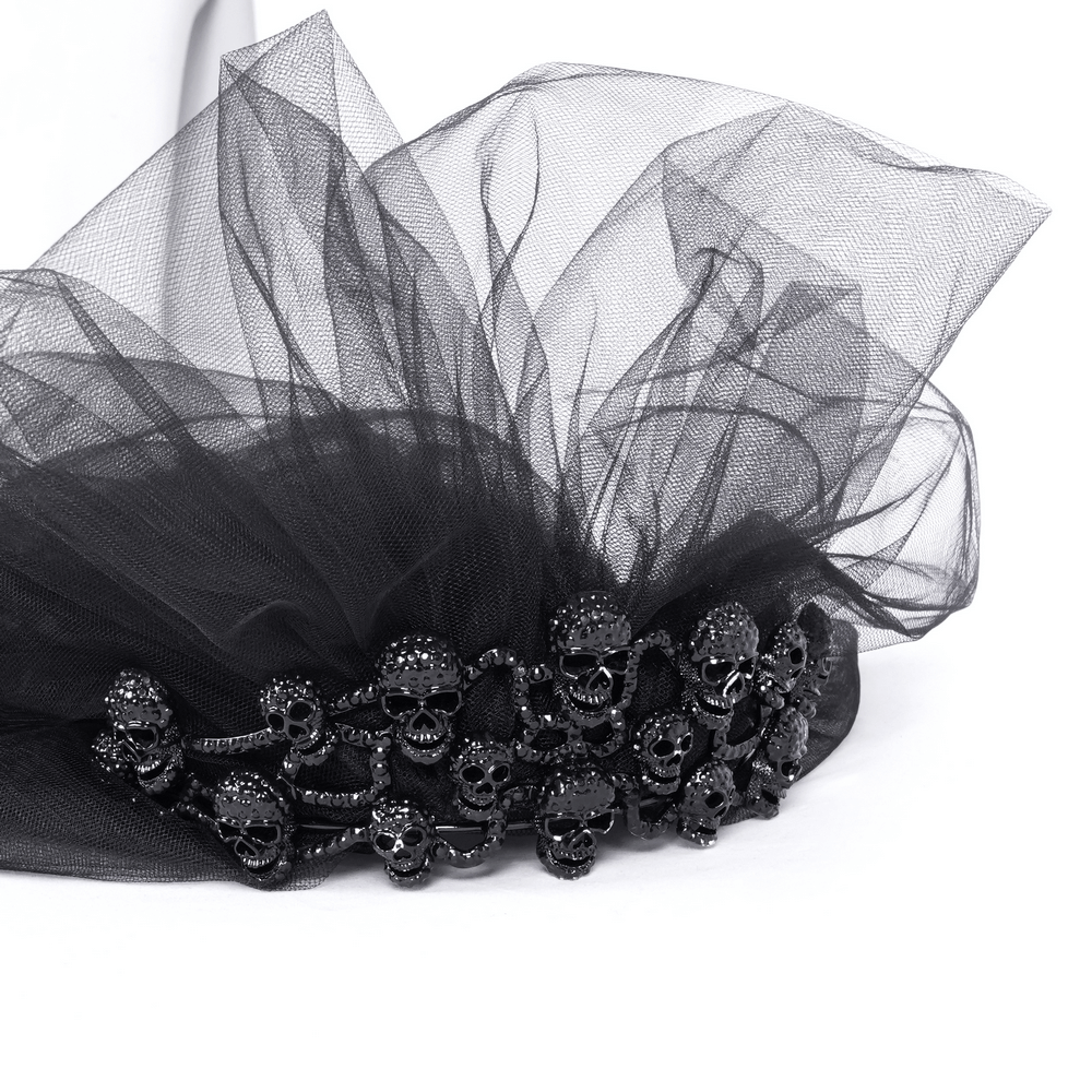 Chic black tulle bridal veil adorned with skull embellishments, perfect for a unique and edgy wedding look.