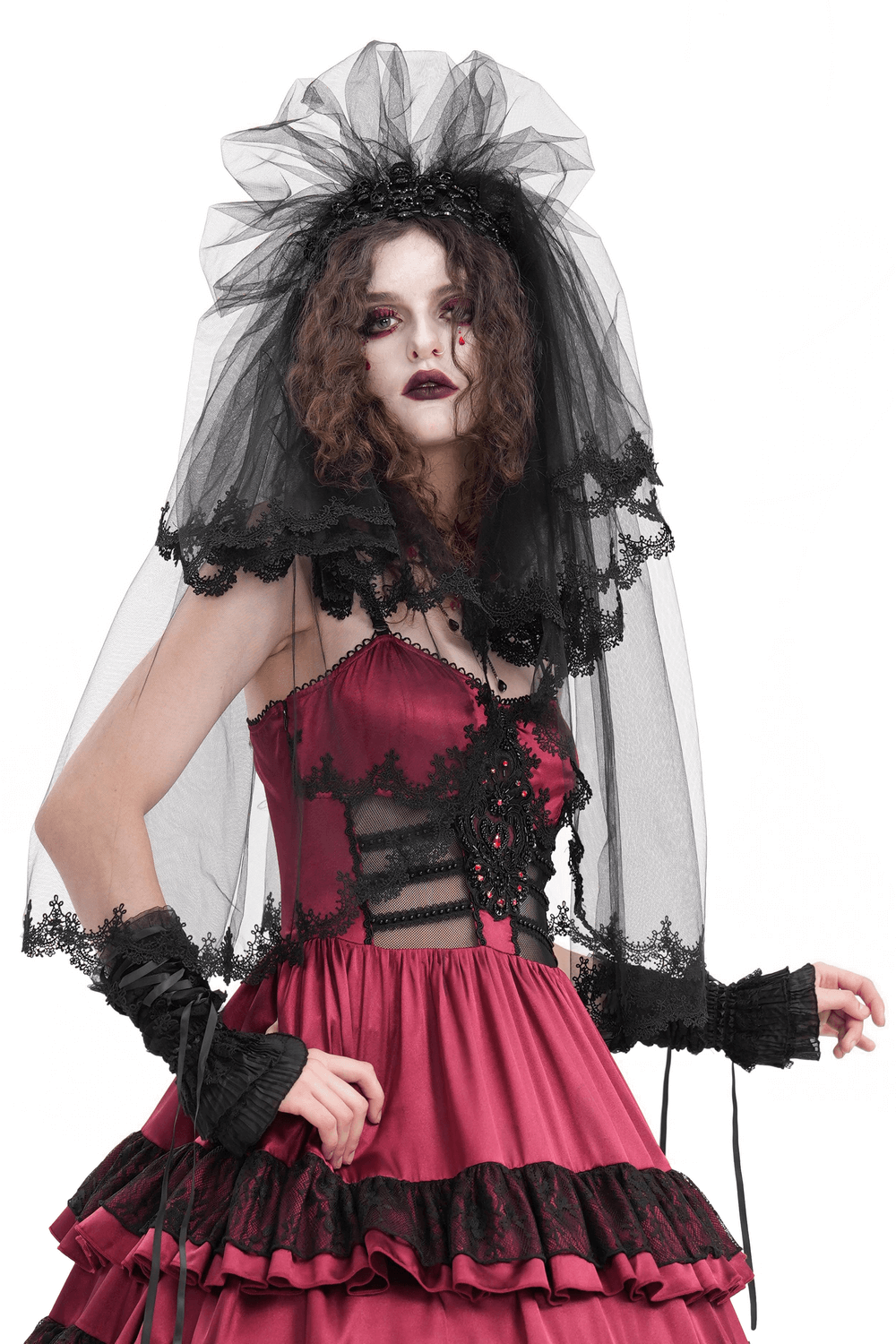 Elegant black lace bridal veil paired with a chic red dress, perfect for a mysterious wedding look.
