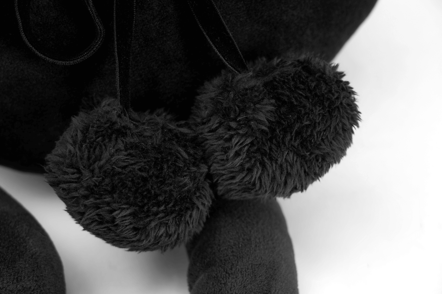 Close-up of soft black pom-poms on the enchanting Mystic Faceless Cat Toy, perfect for gothic decor.