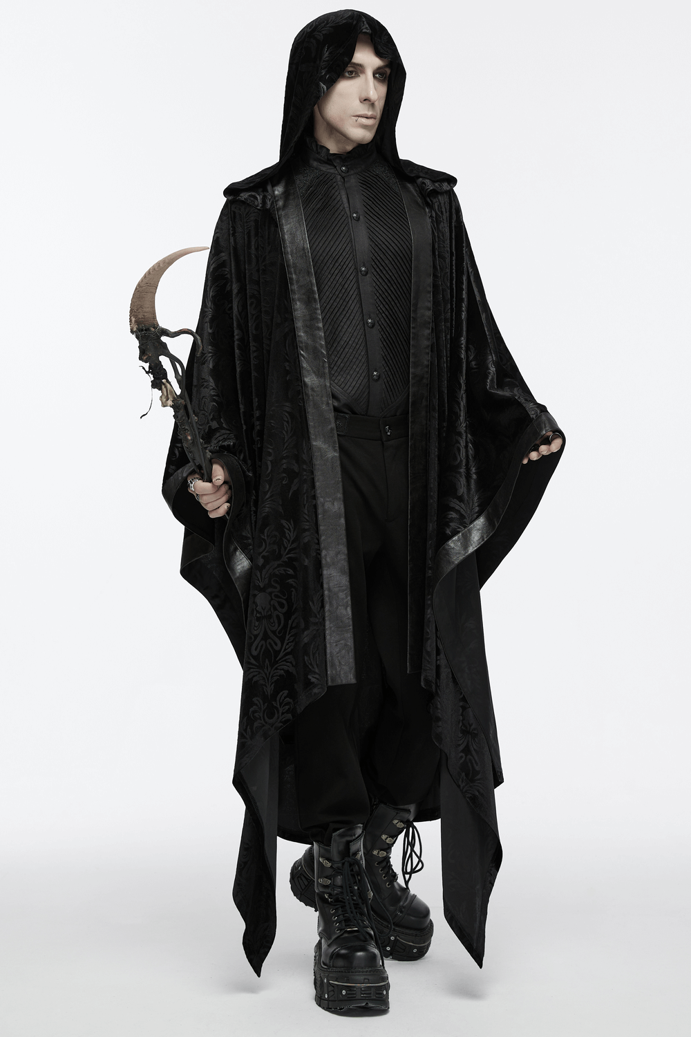 Dark mage in a mystic hooded velvet cape holding a scythe, showcasing gothic elegance and style.