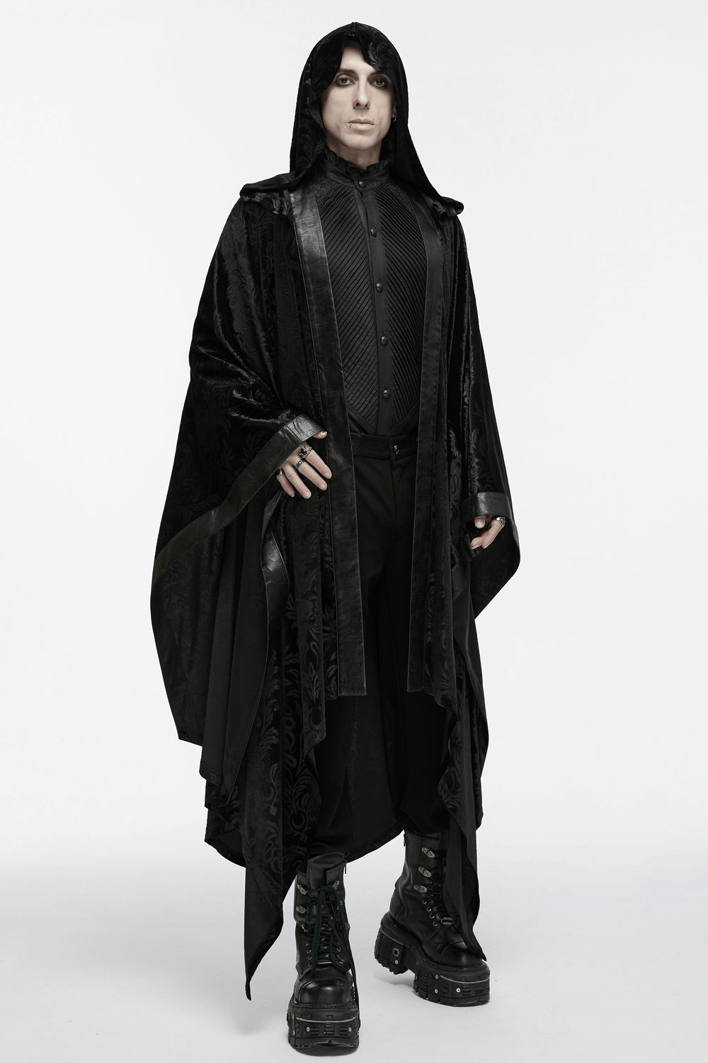 Man wearing a Mystic Hooded Velvet Cape, showcasing a gothic style with dark attire and boots, perfect for enthusiasts.