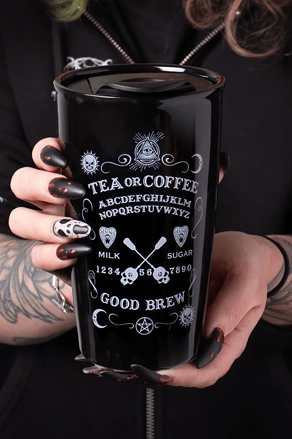 Mystical travel mug with occult design featuring skulls, perfect for tea or coffee lovers on the go.