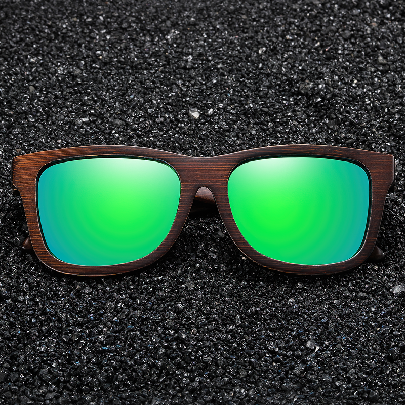 Natural bamboo wooden sunglasses with polarized green mirror lenses on black background.