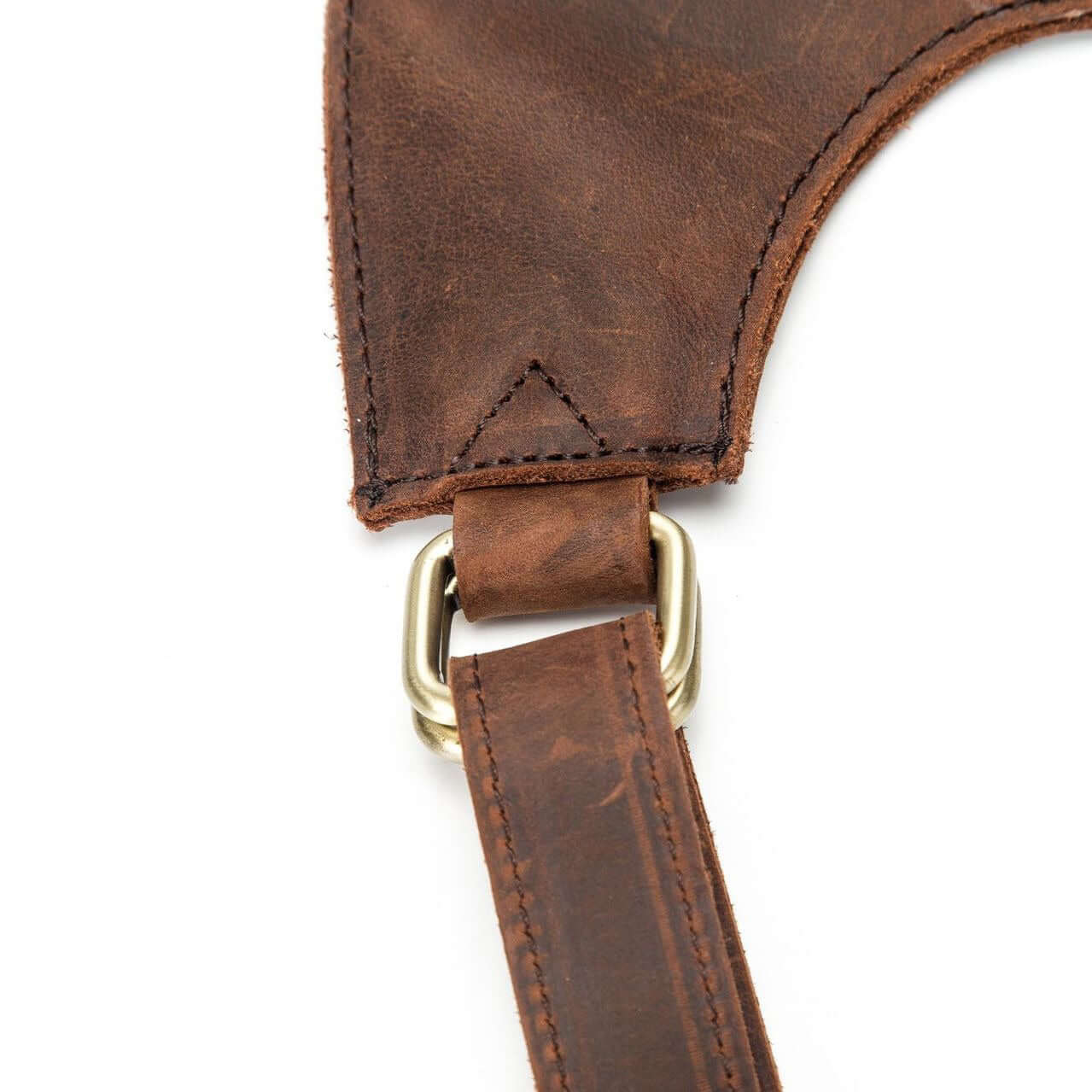 Close-up of a leather strap on a natural leather backpack for women, showcasing its vintage style and sturdy hardware.