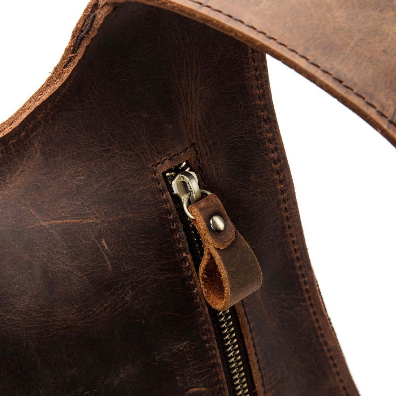 Close-up of the antique zipper on a natural leather backpack for women, showcasing the vintage design.